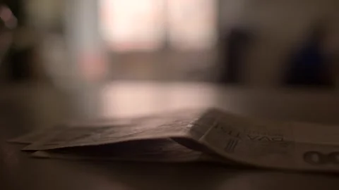 A document is placed on a tabletop, with a softly blurred background creating a  Stock Footage 297202085