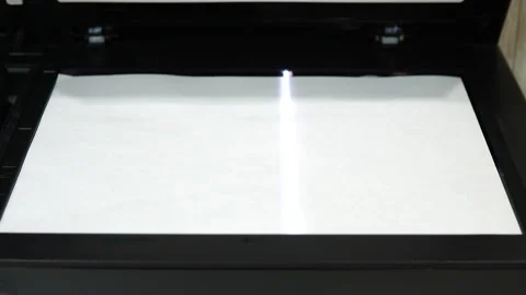 Document scanning process. Scanner in operation scans a sheet of paper with the Stock Footage 146319002