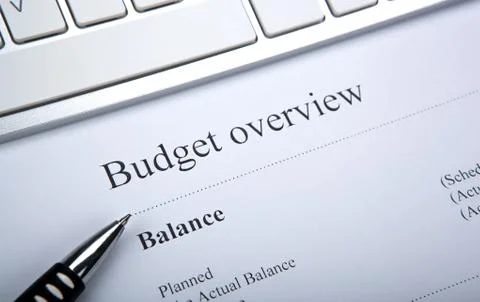 Document with title budget overview and keyboard Foto stock
