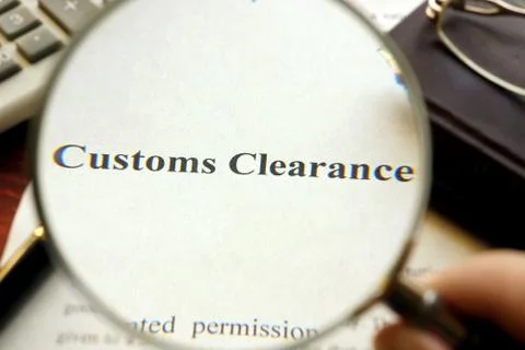 Document with title Customs Clearance on a table. Selective focus. Stock Photos