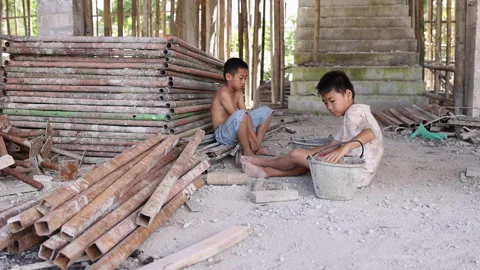 Documentary-style image of two children working inside a building under construc Stock Footage 336951331