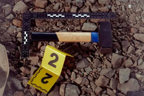 Documentation of suspicious tool by technician in terrain Stock Photos