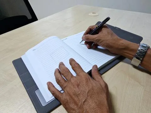 Documenting ideas for better decisions – hand writing in notebook Foto stock