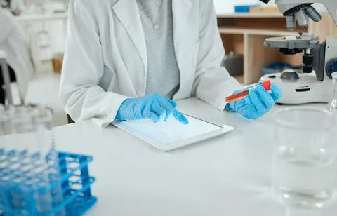 Documenting our progress digitally. a scientist holding a sample while using a Stock Photos