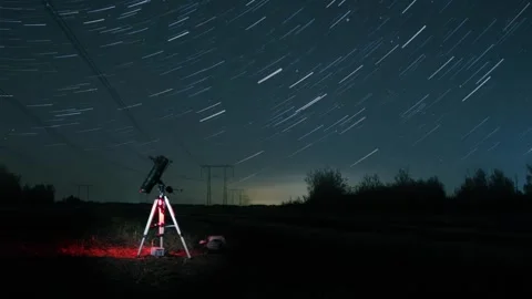 Documenting Perseid meteor activity with extended exposures amidst farmland at Stock Footage 343946805