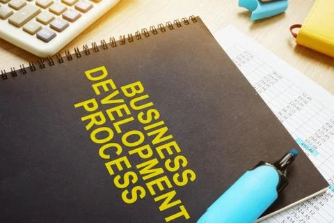 Documents about Business development process on a desk. Stockfoto's