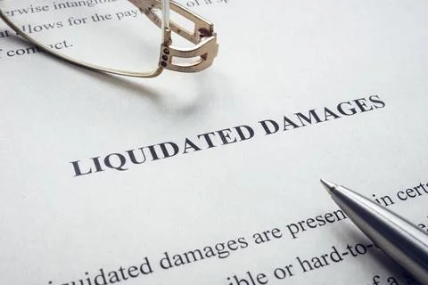 Documents about Liquidated damages with pen and glasses. Stock Photos