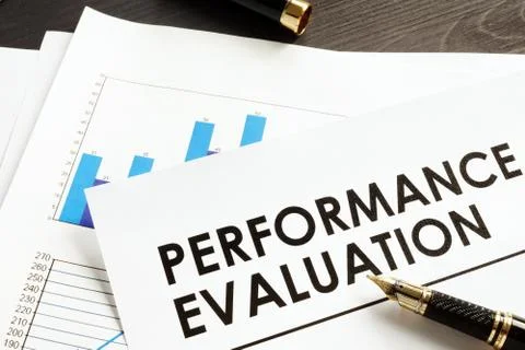 Documents about performance evaluation on a desk. Stock Photos