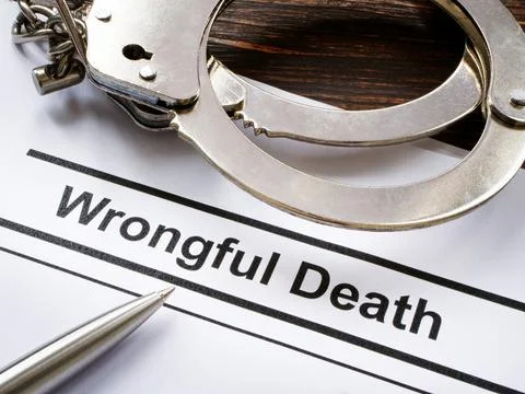 Documents about Wrongful death and metal handcuffs. Stock Photos