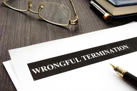 Documents about Wrongful termination on a wooden desk. Stock Photos