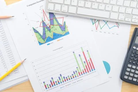 Documents analyze graphs with calculator on office desk Stock Photos
