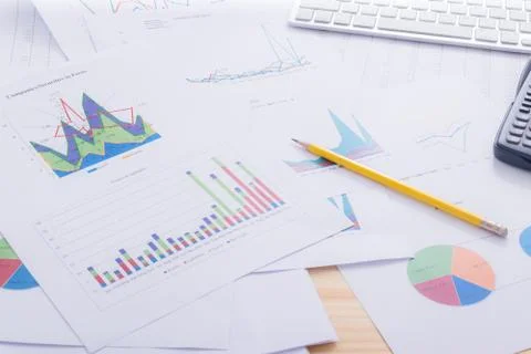 Documents analyze graphs with calculator on office desk Stock Photos