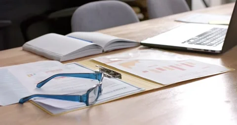 Documents and laptop on table at home, slow motion Stock Footage 337932419