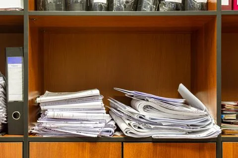 Documents and working drawings of large format are sloppy on the shelf of the Stock Photos