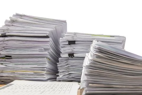 Documents on desk stack up high waiting to be managed 스톡 사진