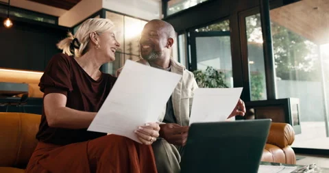 Documents, finance and high five with interracial couple on sofa in home living Stock Footage 337921789