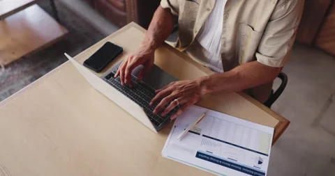 Documents, hands and laptop with man in coffee shop for budget, financial report Stock Footage 330076856