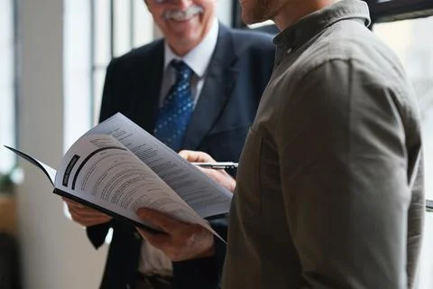 Documents, hands and men in office with finance data, coaching or conversation f Stock Photos