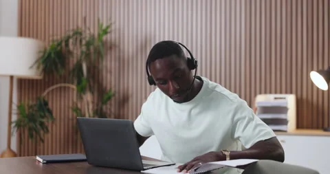 Documents, headset and laptop with black man in call center for assistance, help Stock Footage 329822139