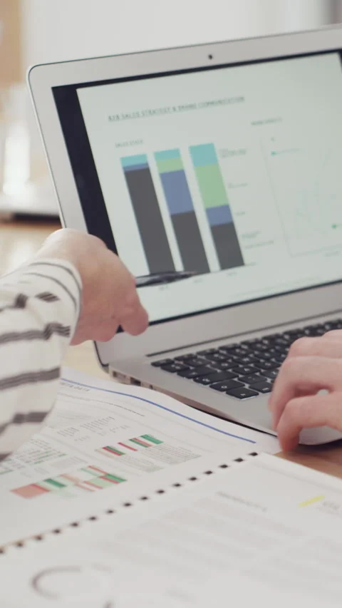 Documents, laptop screen and hands of business people in office with finance Stock Footage 329829890