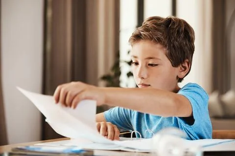 Documents, learning and homework with child in house for education, student.. Stock Photos