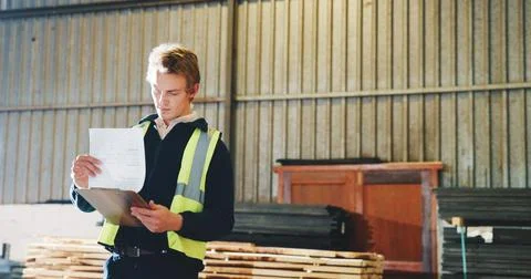 Documents, man and carpenter in workshop with research for industrial project at Stock Photos