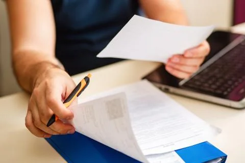 Documents in men's hands. Remote work. A man at a Desk with documents works Stock Photos