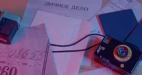 Documents Russian agent on the table. In background in bokeh is camera Stock Footage 197327773