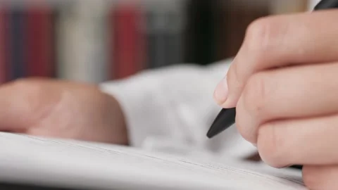 Documents for signature. Female hand puts signature on white sheet of paper Video stock 136012753
