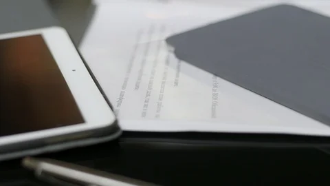 Documents on the table background Slider shot Video stock 94108844