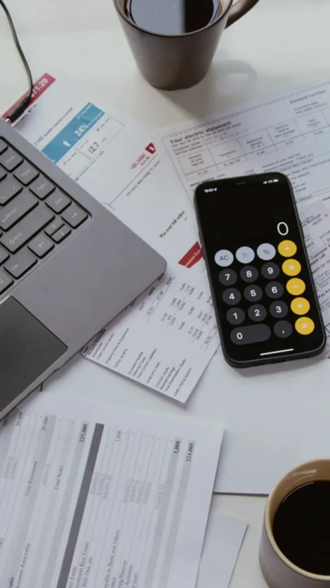 Documents on Table with Open Computer and Calculator Vertical Stock Footage 327685369