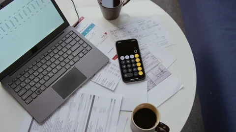 Documents on Table with Open Laptop and Calculator Stock Footage 327680808