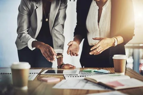 Documents, tablet and hands of business women in office with discussion for.. Stock Photos