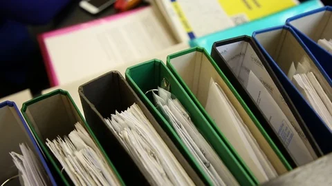 Documents in tech. Theki are lined up. Daylight. Business papers Stock Footage 128295648