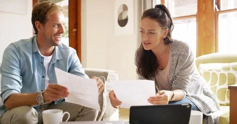 Documents, technology and couple in home planning monthly budget, savings or Stock Photos