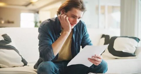 Documents, thinking and man with stress on sofa for financial decision, planning Stock Photos