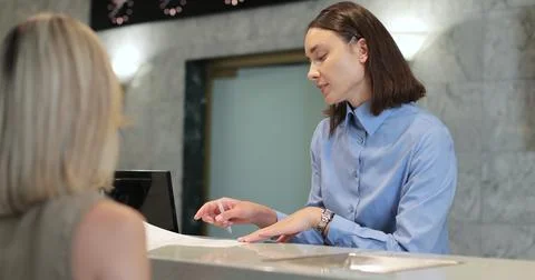 Documents with welcome at hotel, concierge and business trip with discussion for Stock Photos