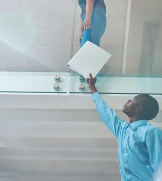 The documents you requested...a young businessman handing a document to a Stock Photos