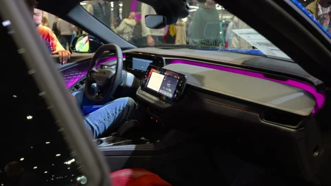 Dodge Charger interior of displayed at an auto show exhibition with visitors Stock Footage 330988125