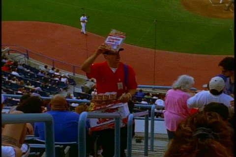 Dodger Stadium, crowd, vendor climbs stairs hawking Crackerjacks Stock Footage