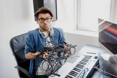 Doesn't know what to do with wires and cords and cables. DJ in broadcasting Stock Photos