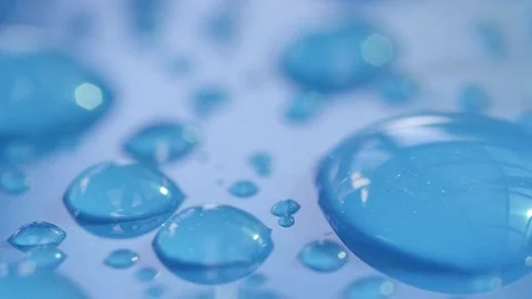 DOF, MACRO, CLOSE UP: Different rain droplets creating pattern on blue surface. Video stock 82921965