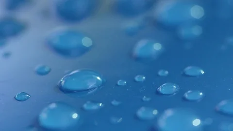 DOF, MACRO, CLOSE UP: Different rain droplets creating pattern on blue car roof. Video stock 82922169