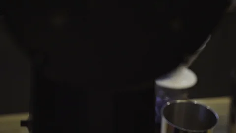 DOF shot of ground coffee in a filter and drops falling into the rippling Видео 86155366