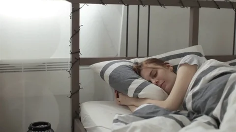 The Dog Awakens the Sleeping Beautiful Girl on the Bed Stock Footage
