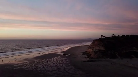 Dog Beach Low Tide Post-Sunset Aerial by Drone Helicopter with cliffs Stock Footage 84088926