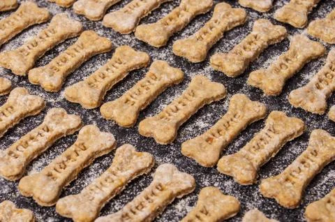 Dog biscuits on black background Stock Photos