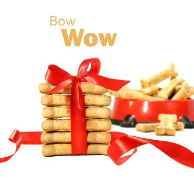 Dog biscuits wrapped with red bow on white Stock Photos