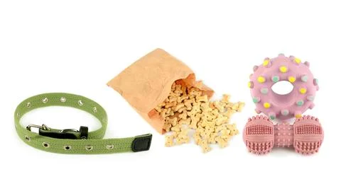 Dog collar bone shaped biscuits in paper bag and rubber toys isolated on wh.. Stockfoto's