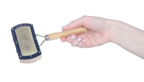 Dog comb brush in hand Stock Photos